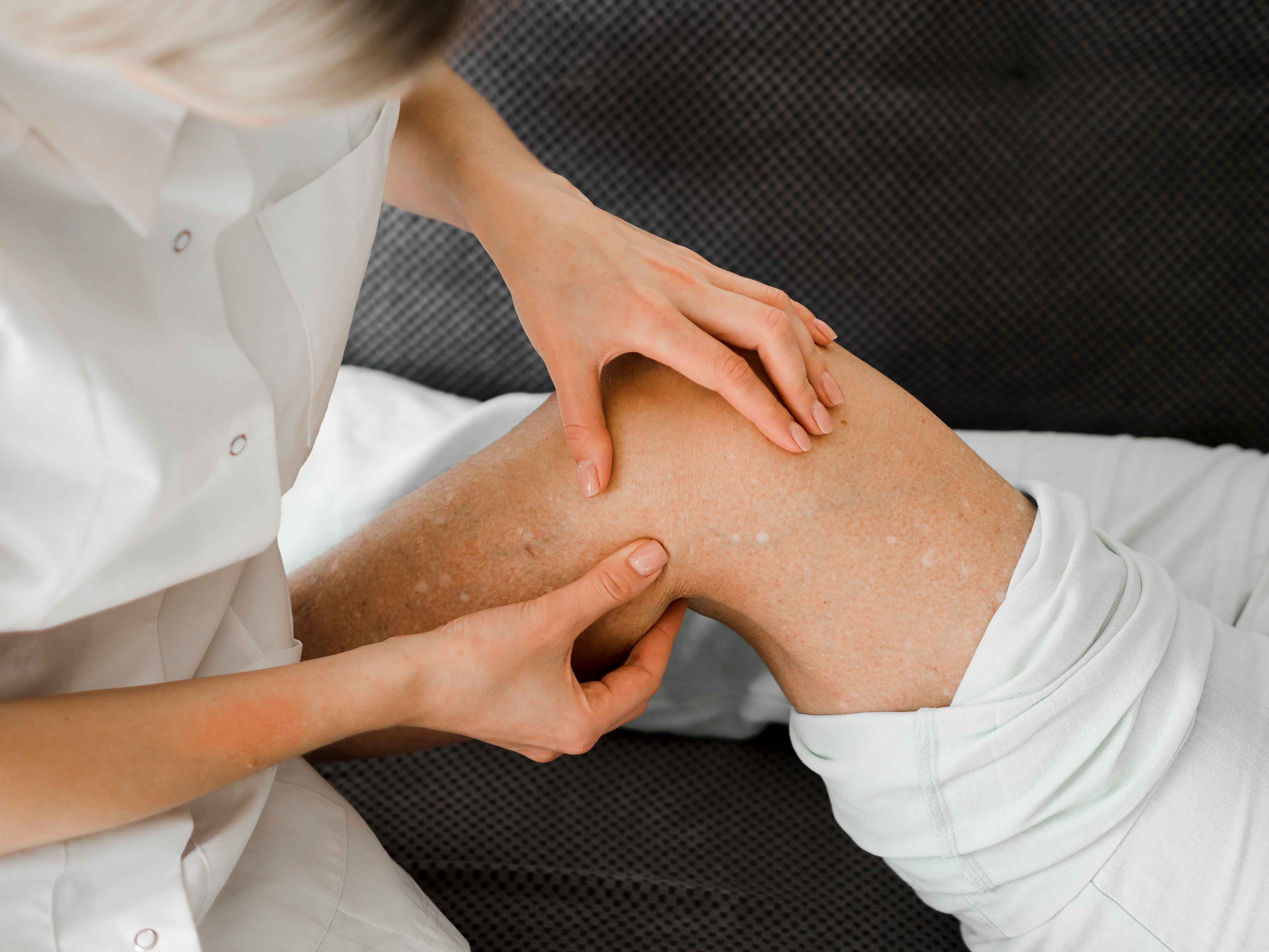 doctor checking patient s leg